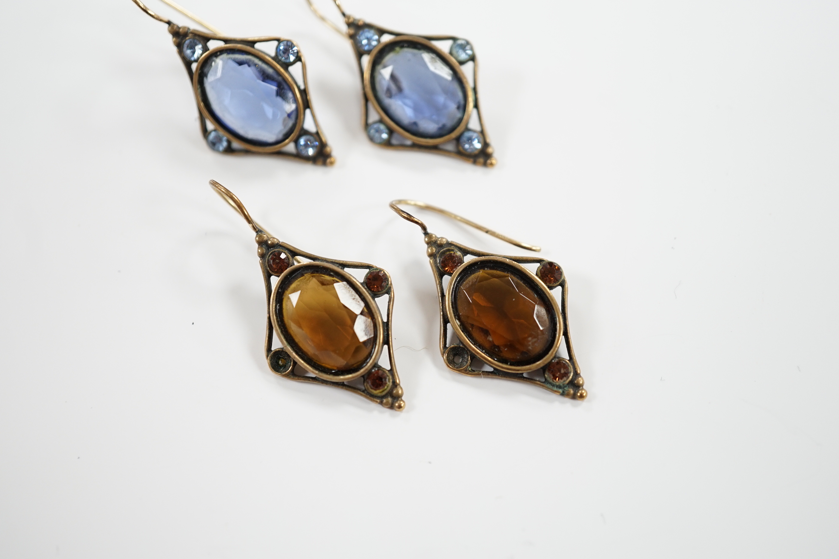 Two pairs of early 20th century gilt metal and coloured paste set drop earrings, overall 37mm.